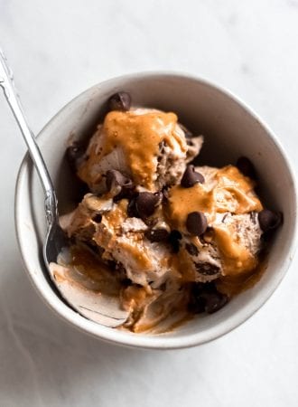 Bowl with 3 scoops of vegan peanut butter chocolate chip banana ice cream.