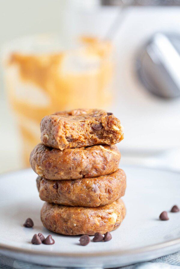 A stack of 4 no-bake cookies on a white plate.