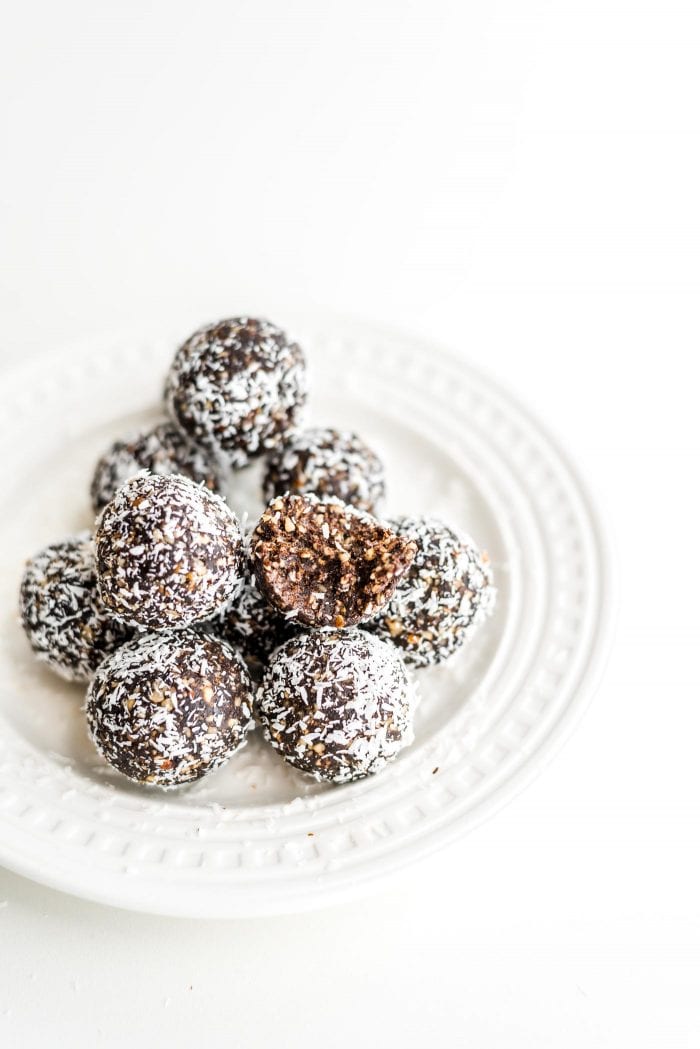 Easy, healthy, no-bake raw vegan hazelnut truffles on a white plate.