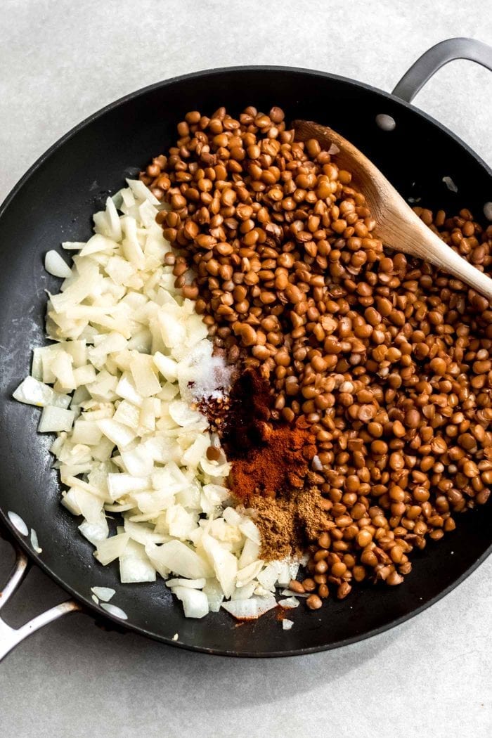 Onions, garlic, taco seasoning and lentils in a skillet.