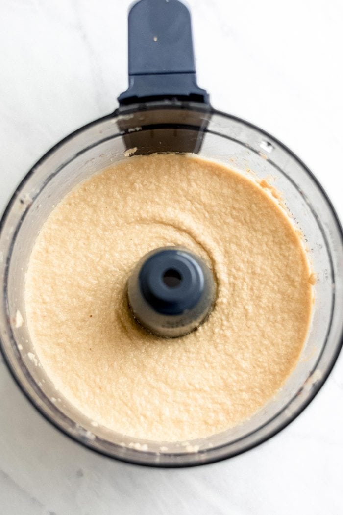Raw cheesecake filling in a food processor.