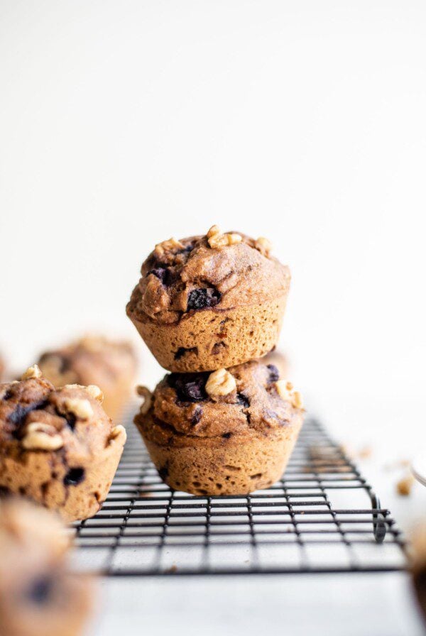 Vegan blueberry muffins sitting on a cooling rack.