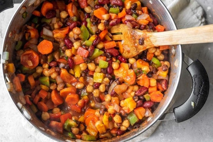A pot of 3 bean chili with carrots and celery.