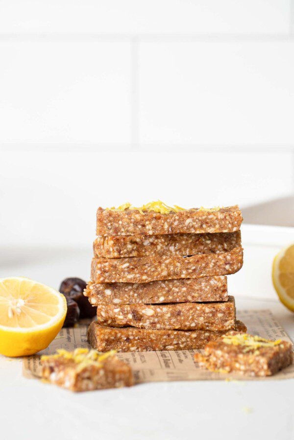 A stack of lemon energy bars on a kitchen counter.