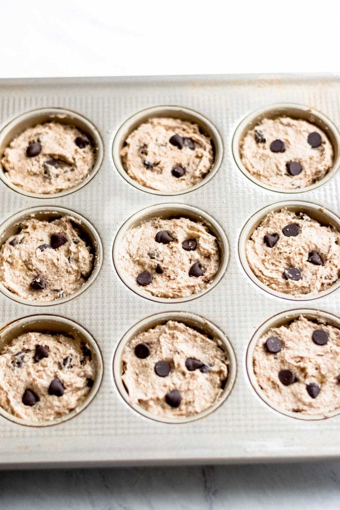Raw muffin batter in muffin tins.