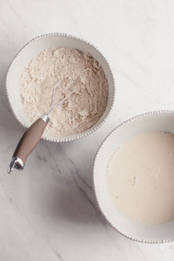 One bowl with flour and coconut, one bowl with almond milk.