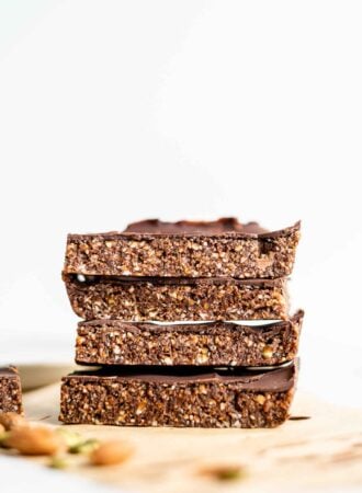 A stack of 4 large energy bars sitting on parchment paper.