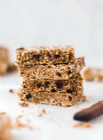 Stack of 4 paleo energy bars with hemp seeds, coconut and raisins.
