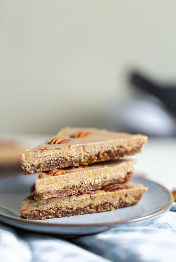 3 slices of raw vegan maple pecan pie on a small grey plate.