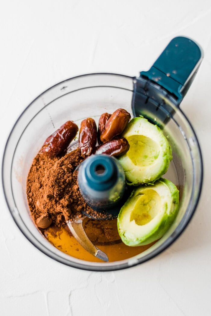 Avocado, cocoa powder, dates and maple syrup in a food processor.