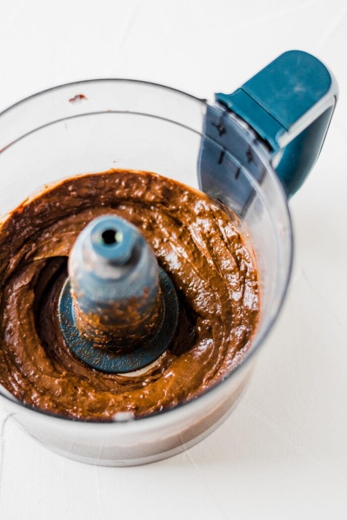 Blended chocolate avocado pudding in a food processor.