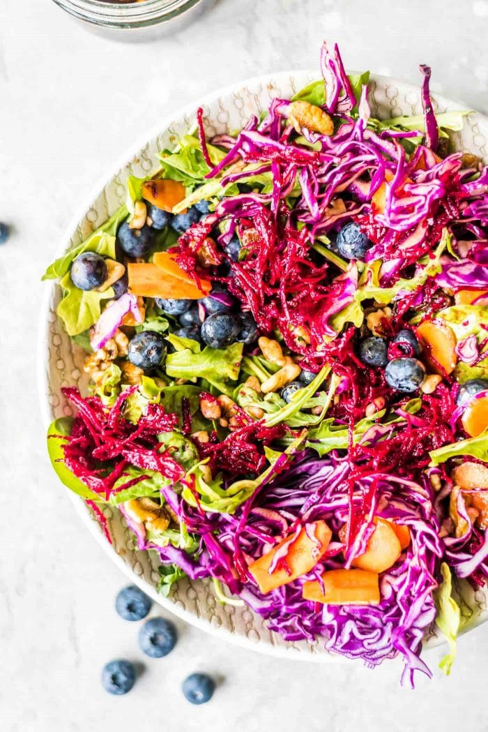Cabbage, blueberry and carrot salad with beet, walnuts and raisins.