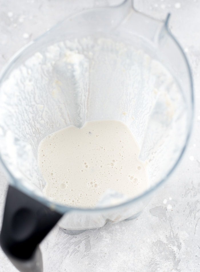 Cashew cream blended up in a Vitamix blender container.