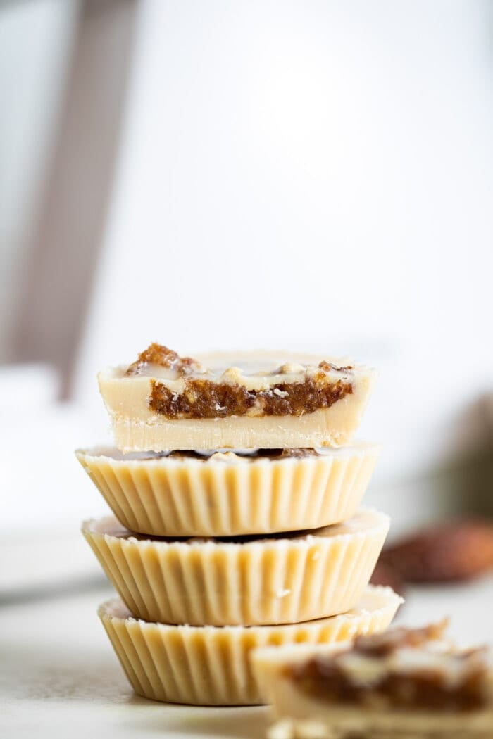 A stack of tahini cups filled with date caramel.
