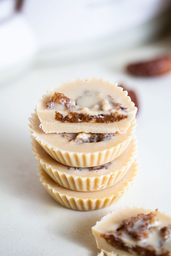 A stack of tahini cups filled with date caramel.