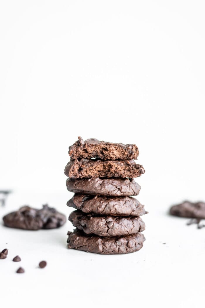 Stack of 4 chocolate cookies with a cookie on top showing the inside texture of the cookie.