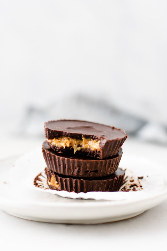 Stack of 3 vegan peanut butter banana cups on a small white plate.