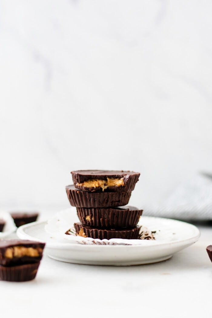 A stack of 4 peanut butter banana chocolate cups on a small plate.