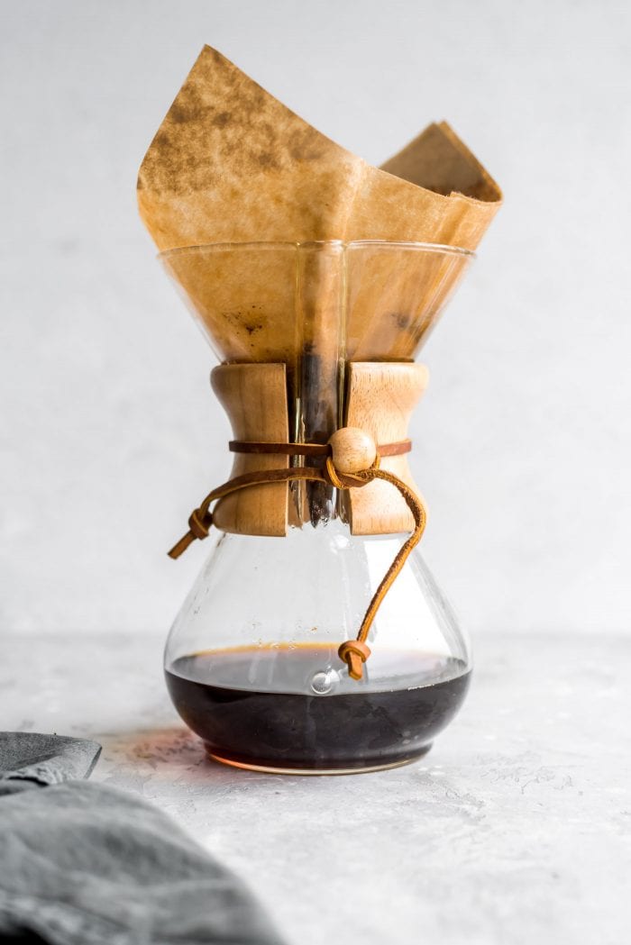 Chemex coffee maker with brewed coffee in it.