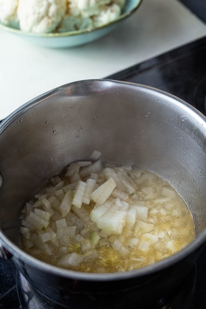 Onions, garlic, ginger and broth in a large saucepan on the stovetop.