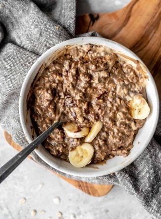 Bowl of vegan mocha protein oatmeal with banana and cashew butter.