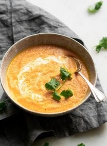 Healthy creamy coconut carrot ginger soup with cilantro.