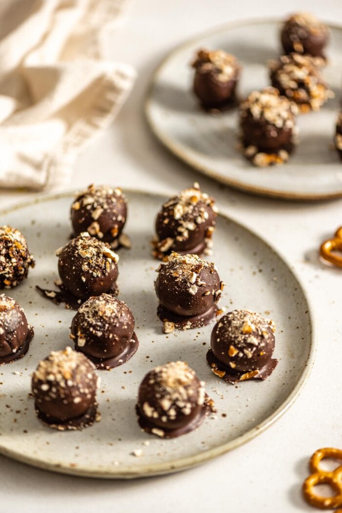 A plate of chocolate truffles sprinkled with crushed pretzels.