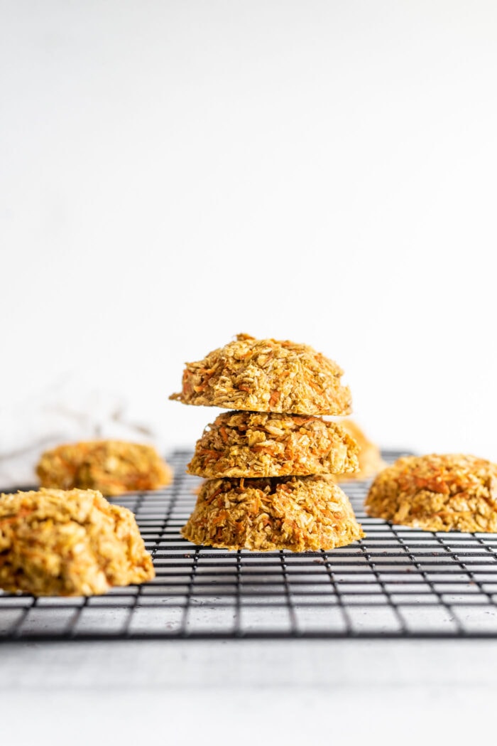 Stack of healthy vegan carrot cookies sitting on a cooling rack.