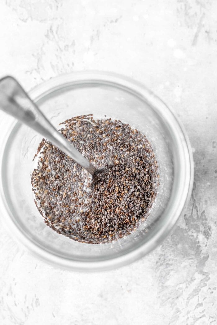 Jar with chia seeds and almond milk in it.