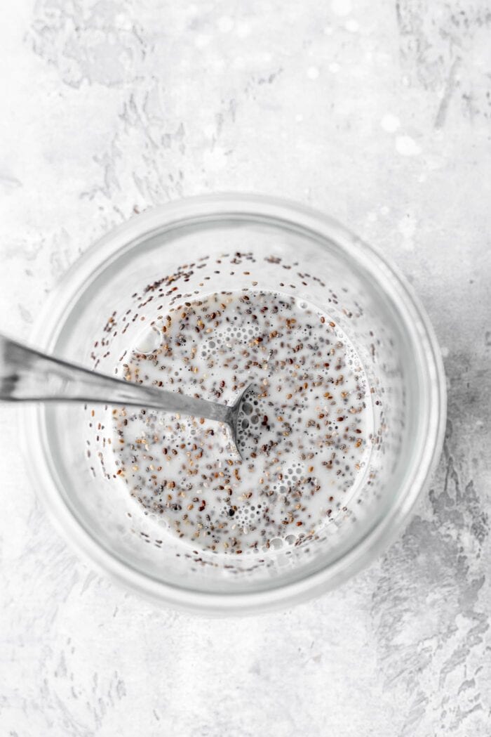 Jar with chia seeds and almond milk mixed together.