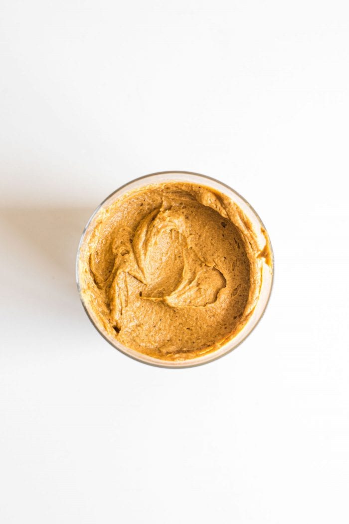 Overhead shot of vegan pumpkin pie protein pudding in a cup.