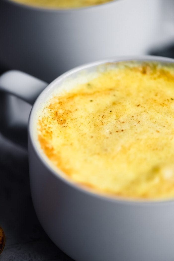 Close up of a mug of turmeric golden milk.