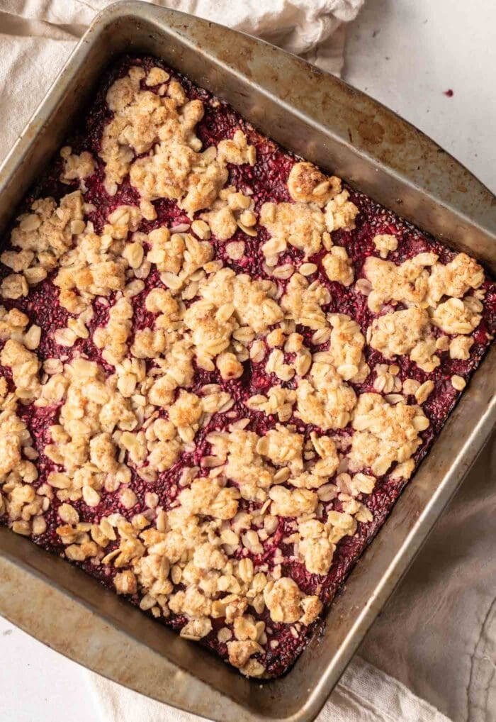 Close up of a baked oat crumble bar in a baking pan.
