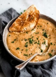 Easy vegan roasted garlic cauliflower soup with fresh bread.