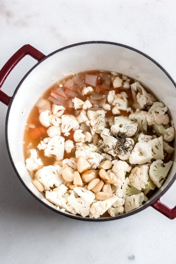 Cauliflower, carrot, onion and roasted garlic in a soup pot.