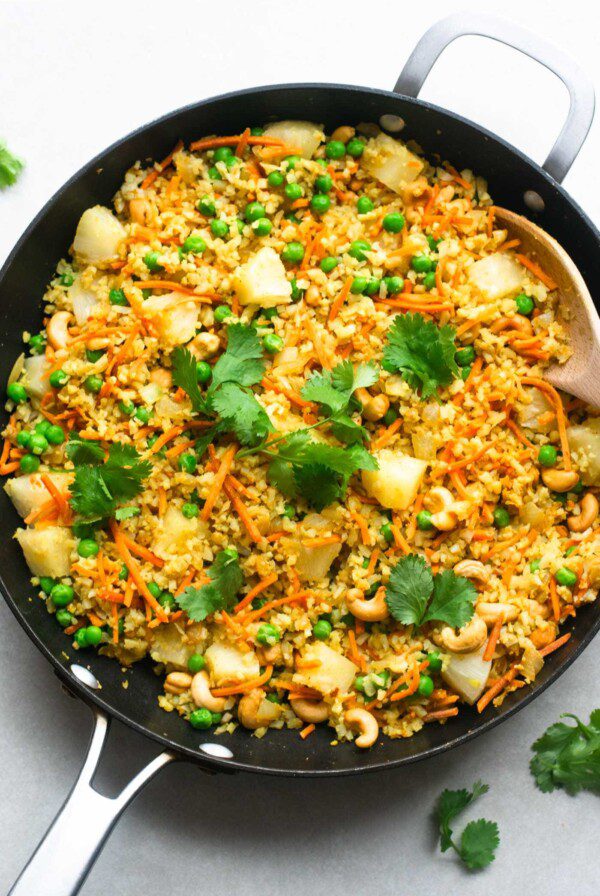 Vegan cashew cauliflower rice with pineapple, peas and cilantro.