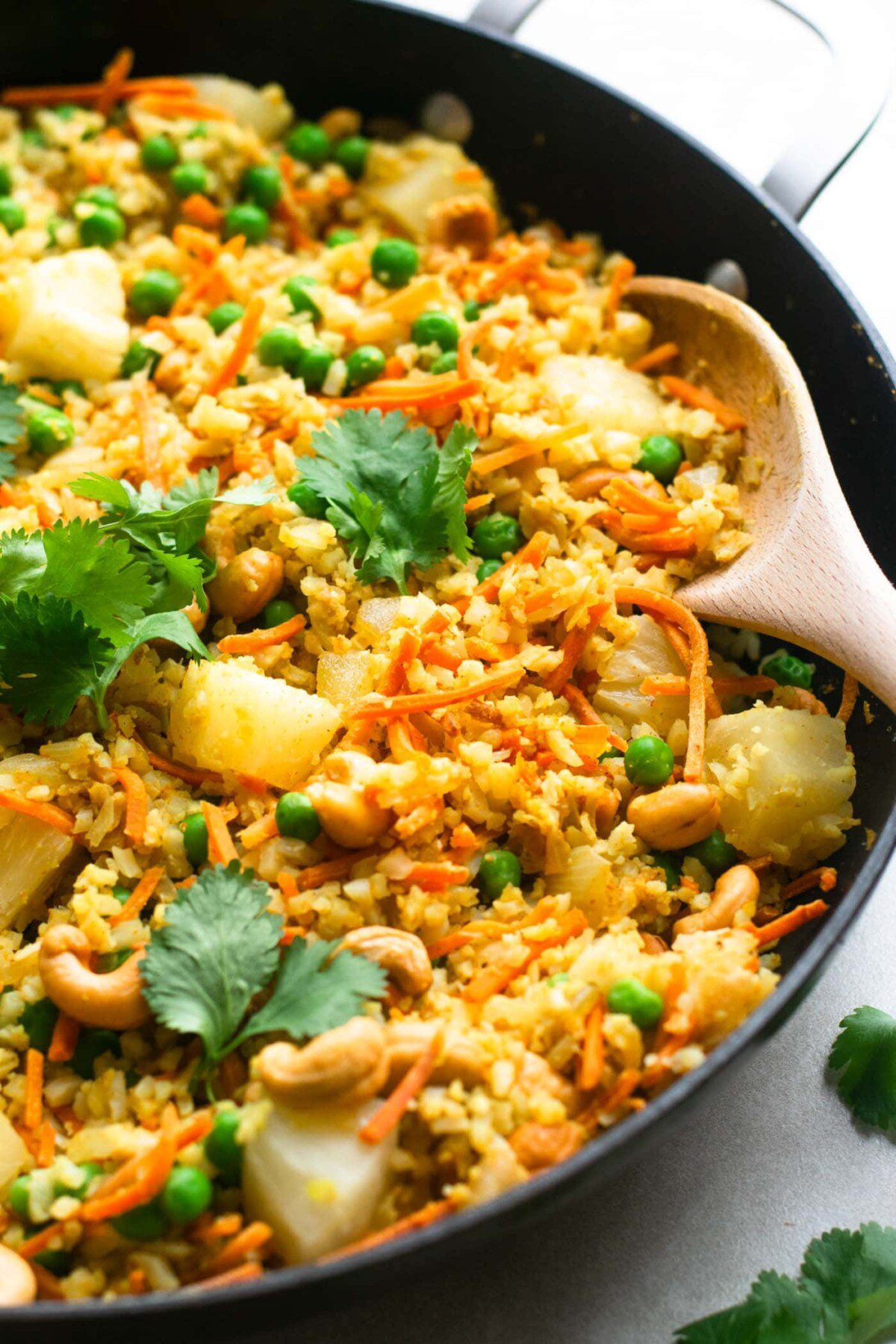 Healthy vegan pineapple cauliflower rice with cashews.