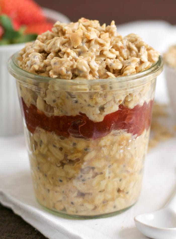 A jar of overnight oats with berries.