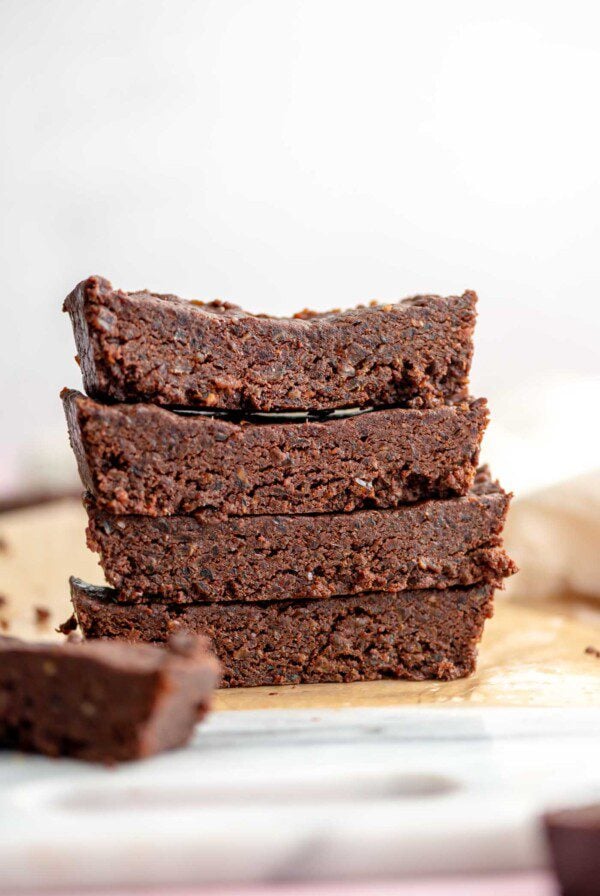 Stack of 4 chocolate protein bars on a marble cutting board.