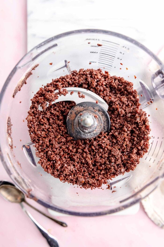 Crumbly chocolate dough in a food processor.