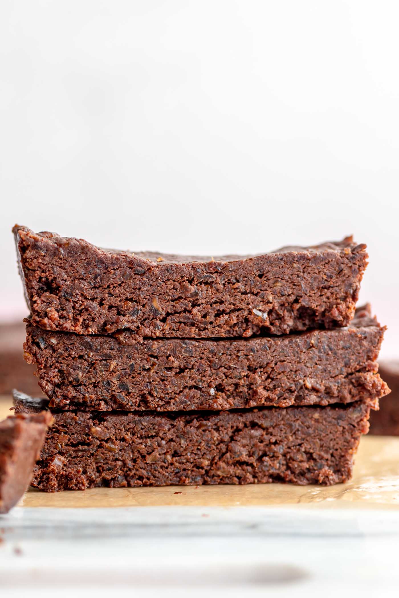 Stack of 3 chocolate protein bars made with dates.