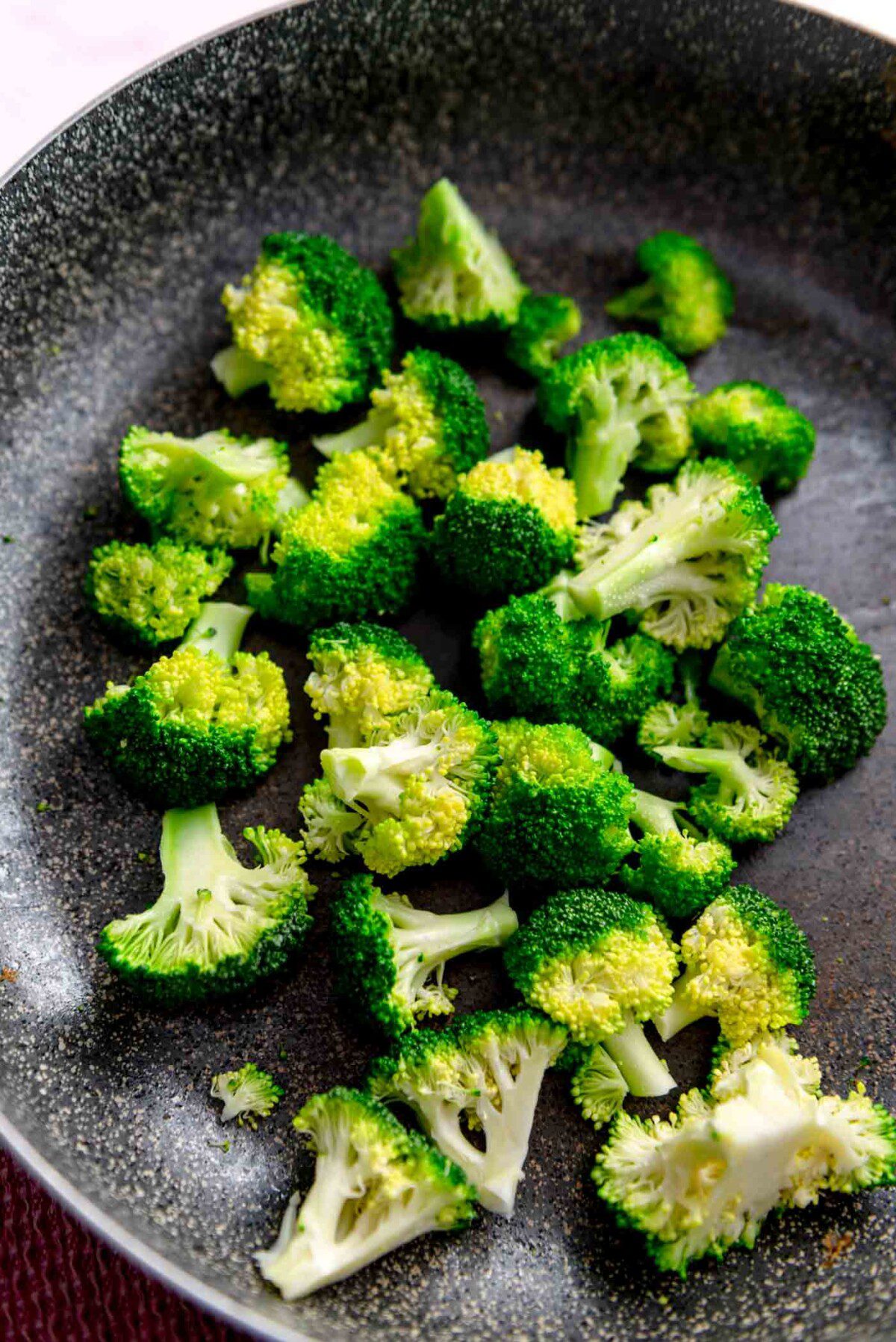 Chopped broccoli in a large skillet.