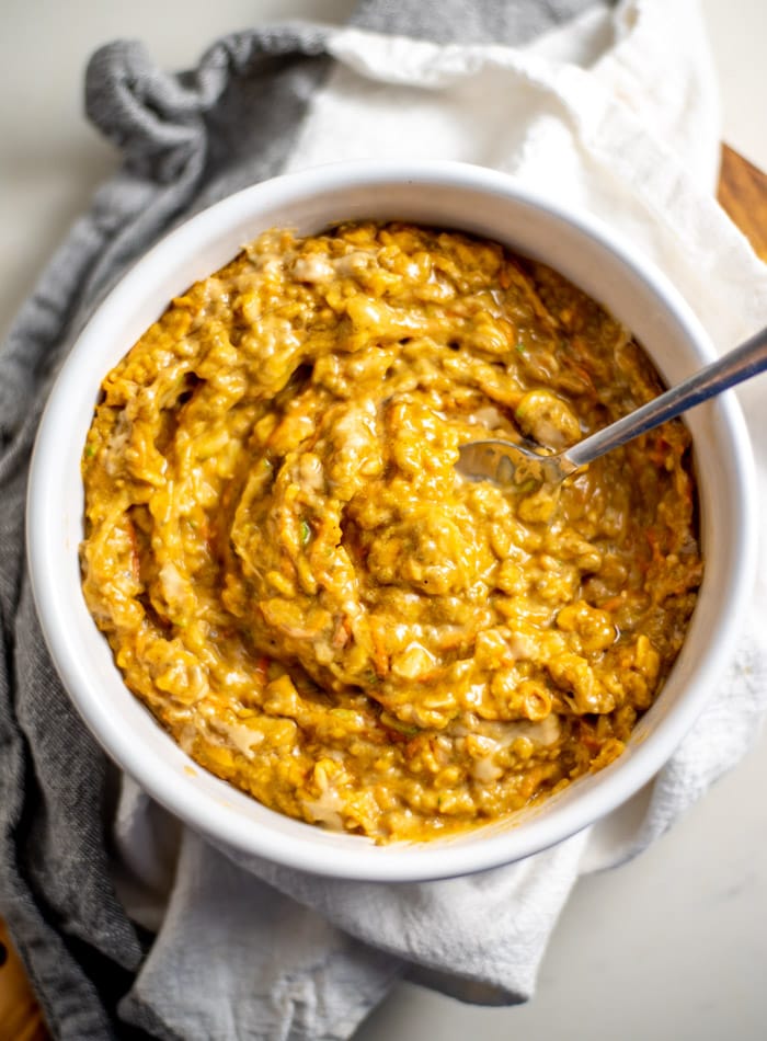 A bowl of creamy oats with pumpkin, zucchini and carrot.