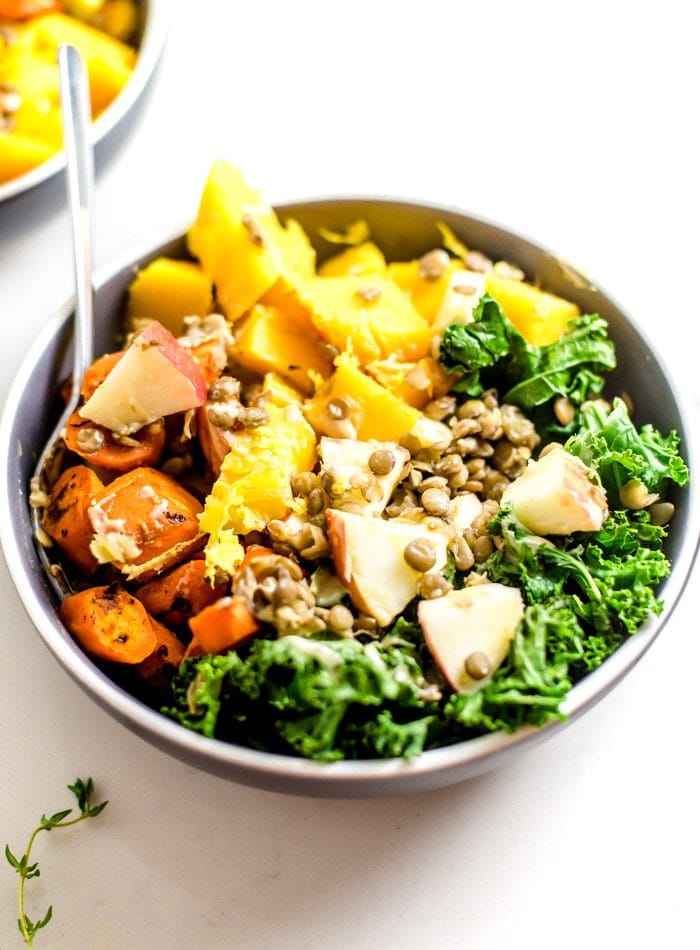 Fall buddha bowl with kale, apple, squash and carrot.