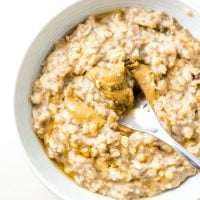 Bowl of banana oatmeal topped with peanut butter.