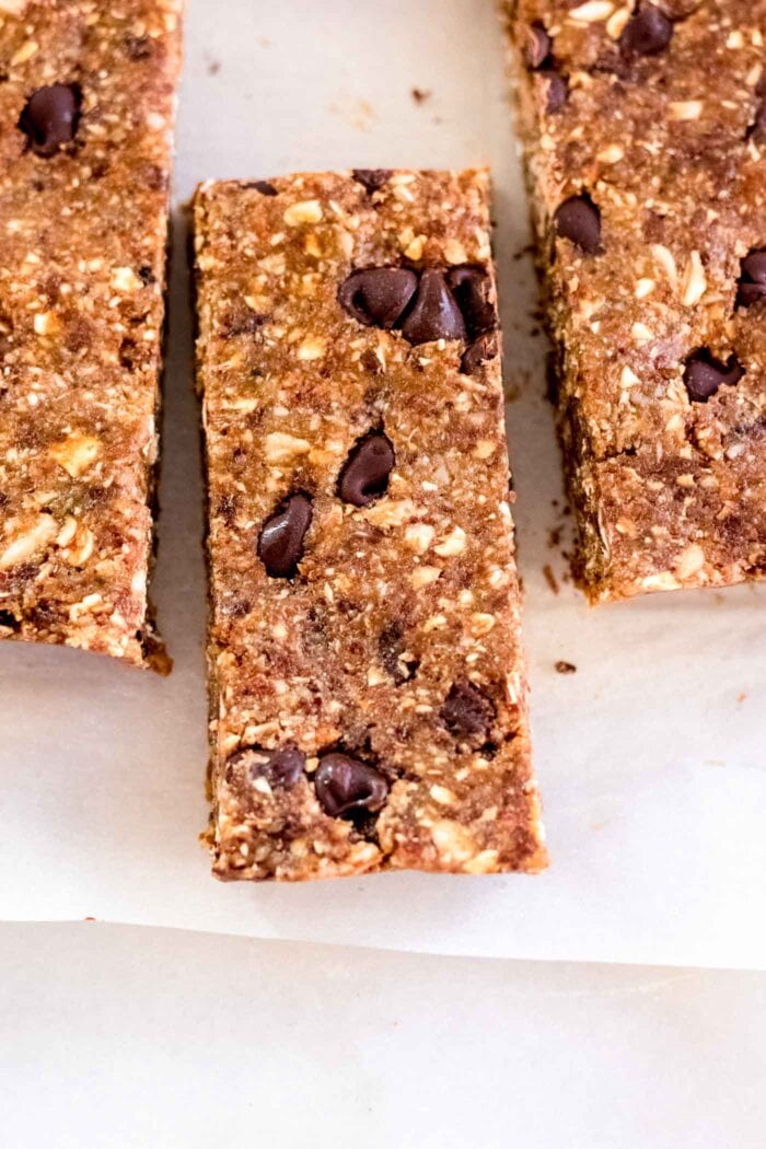 3 chocolate chip granola bars on a piece of parchment paper.