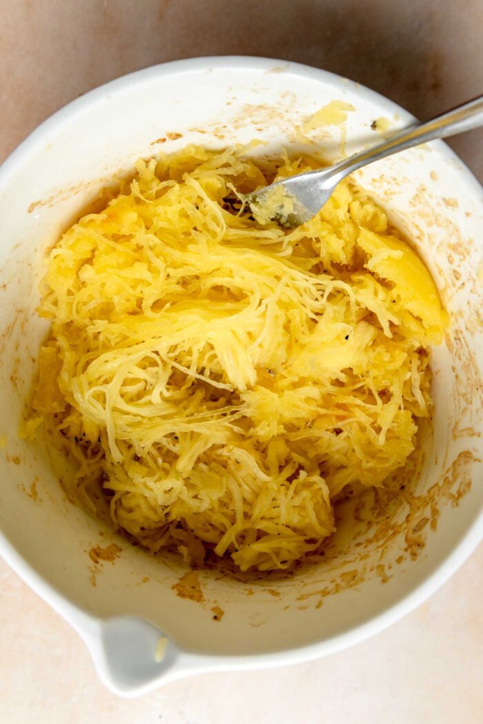 Spaghetti squash noodles in a bowl with a spoon.