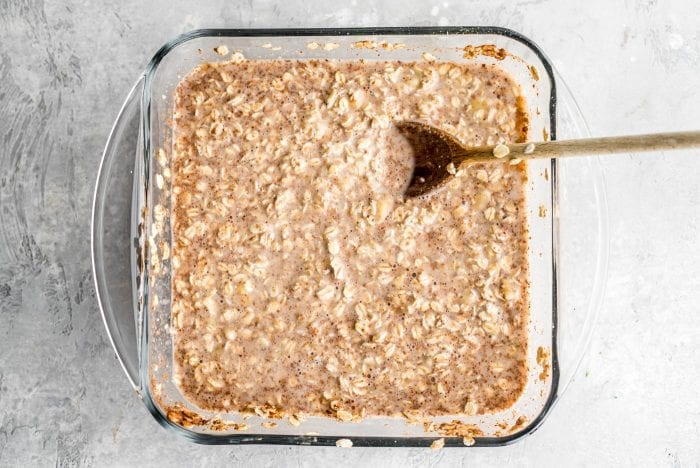 Mixed baked oatmeal ingredients in a glass baking dish before going in the oven.
