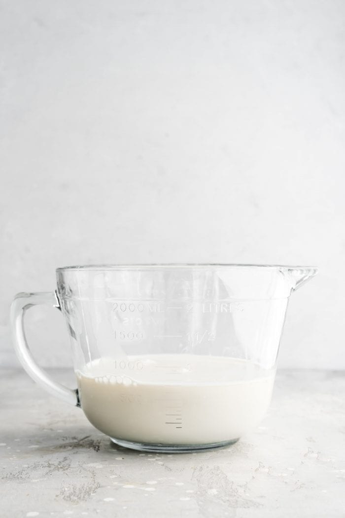 Cheap and easy homemade oat milk in a large glass bowl.