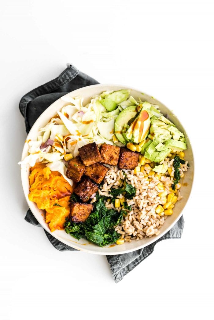 Vegan BBQ tempeh bowls with brown rice, corn and coleslaw.